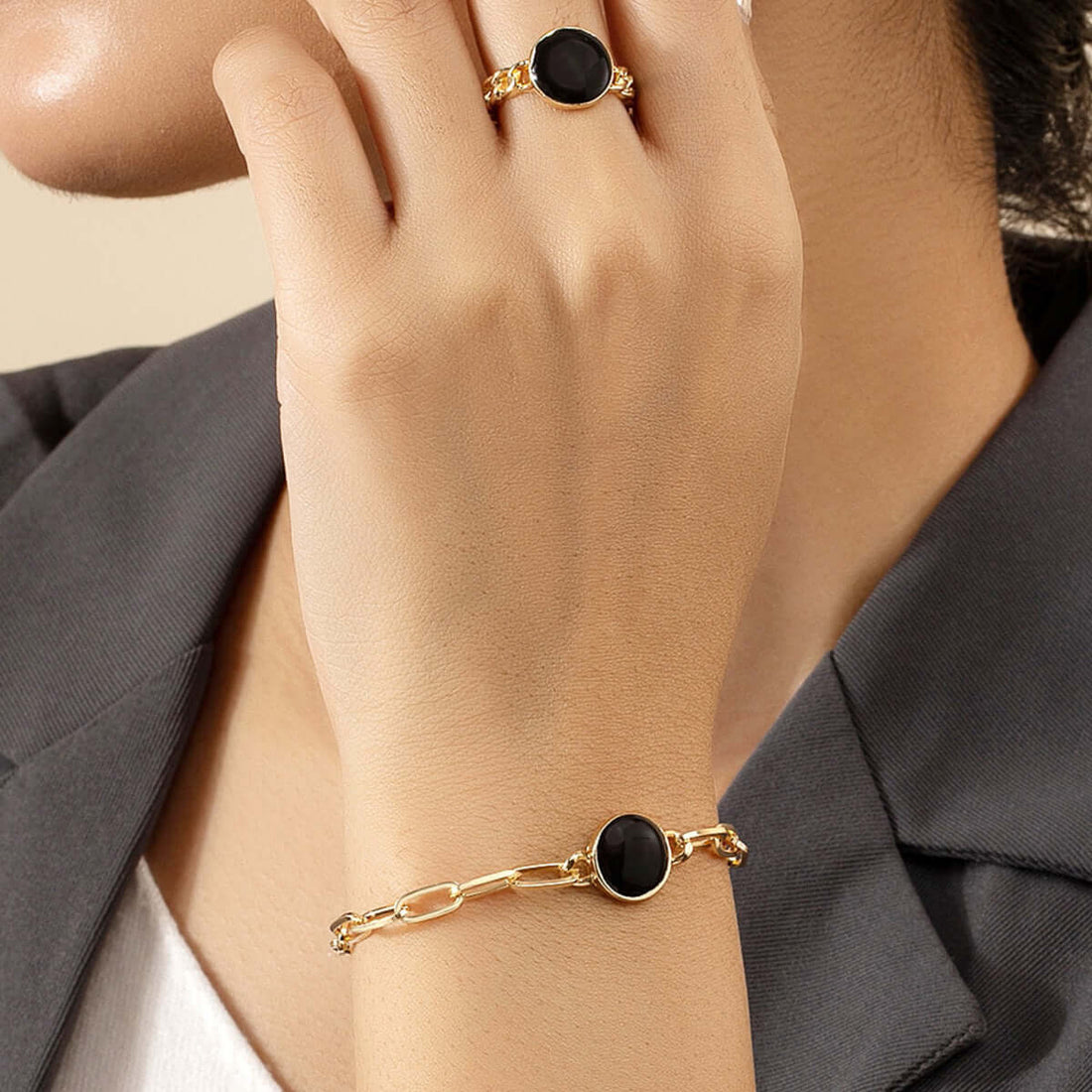 The Meaning Behind Popular Jewelry Types: Elegant black stone ring and bracelet in gold setting.
