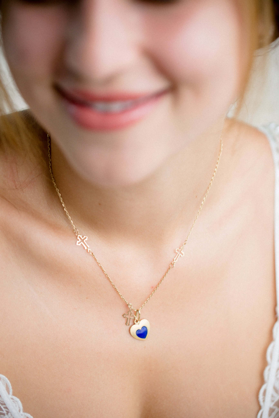 The Ultimate Jewelry Gift Guide: Find the Perfect Piece for Everyone - woman wearing a gold necklace with a heart pendant.