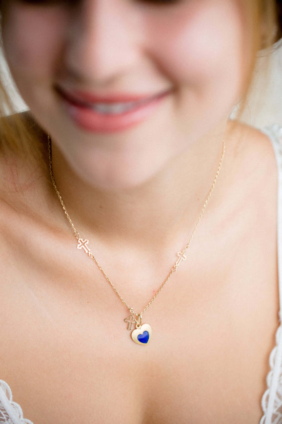 The Ultimate Jewelry Gift Guide: Find the Perfect Piece for Everyone - woman wearing a gold necklace with a heart pendant.