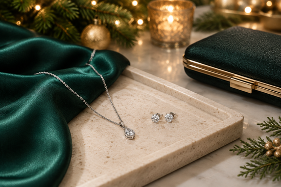 Illustrative silver-tone necklace and sparkling earrings beside emerald satin and softly glowing festive lights.