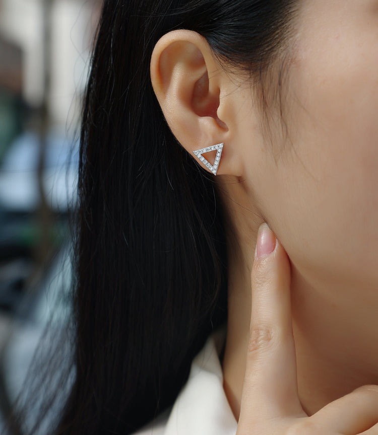 Moissanite earrings set showcased in sterling silver triangle studs worn on a model&