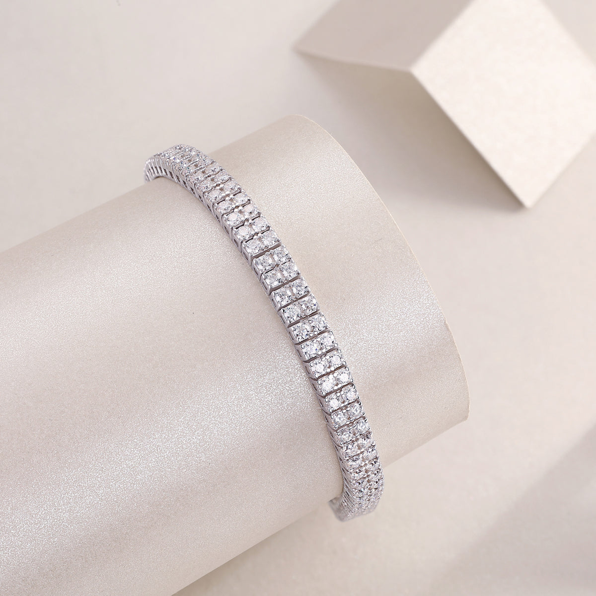 morganite diamond bracelet displayed elegantly on a smooth cylindrical surface with a soft background