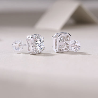 1Heart luxury moissanite diamond stud earrings set with silver ornaments on a light background.