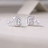 1Heart luxury moissanite diamond stud earrings set with silver ornaments on a light background.