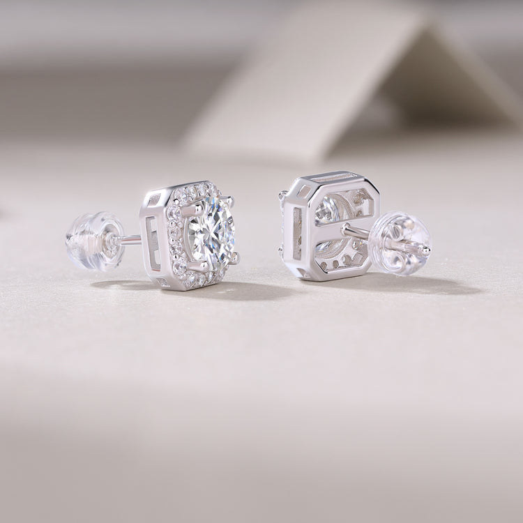 1Heart luxury moissanite diamond stud earrings set with silver ornaments on a light background.