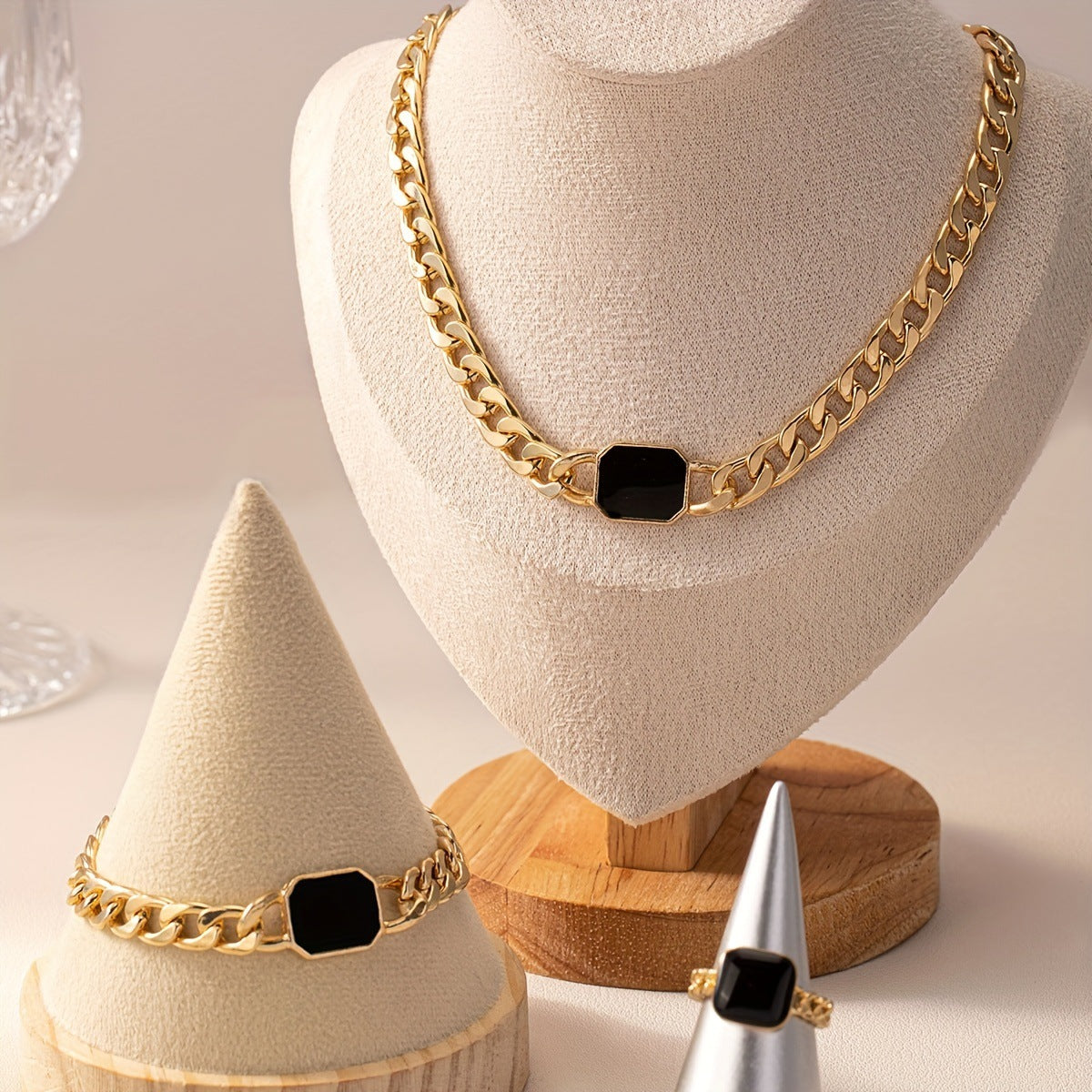 Luxury jewelry gift card featuring a stunning gold necklace, bracelet, and ring displayed elegantly.