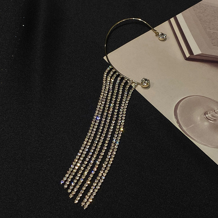 Elegant luxury drop tassel earrings with long sparkling tassels on a dark background.