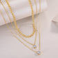 2-carat morganite pendant necklace in layered gold chains with sparkling gemstones.