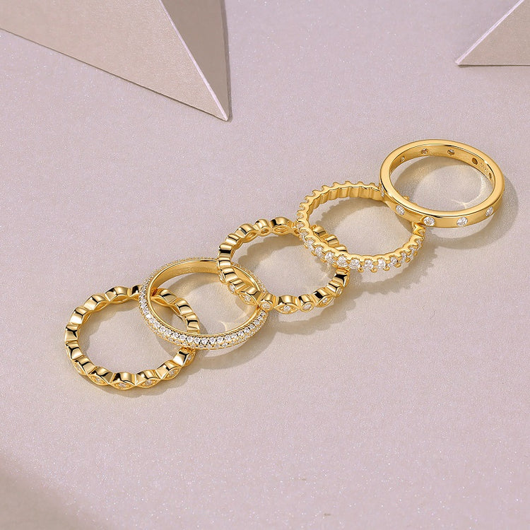 Moissanite wedding ring set featuring five gold plated rings with intricate designs and sparkling details.