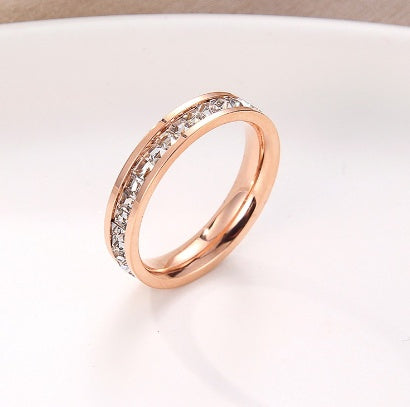 Minimal Titanium Rings For Women featuring a delicate rose gold and crystal design on a white background.