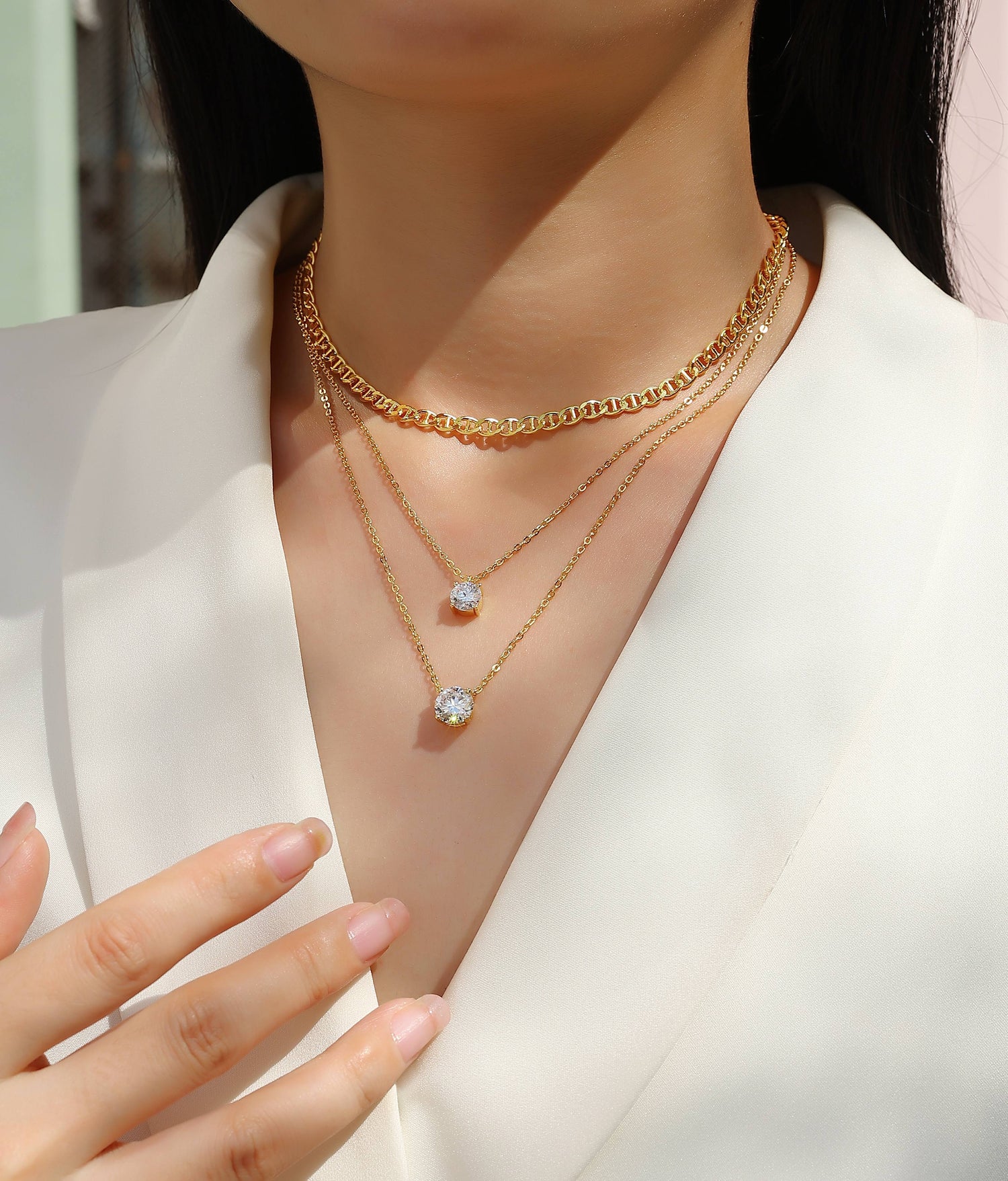 2-carat morganite pendant necklace showcased in layered gold chains on a model&