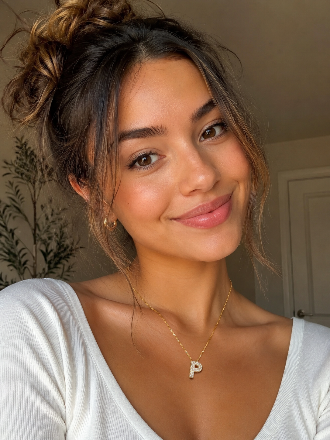 Smiling woman wearing a Personalized Moissanite Initial Necklace with gold-plated S925 silver and bubble letter design.
