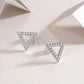 Moissanite Earrings Set – Sterling Silver Studs with triangle design and sparkling stones on a soft background.